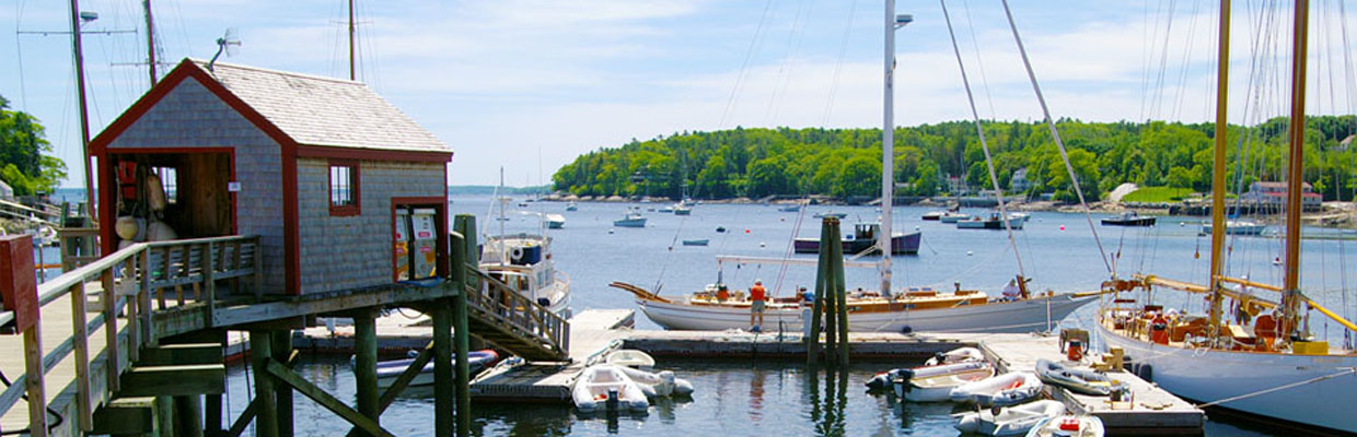 Rockland harbor with boats docked and lobster boats pulling traps..