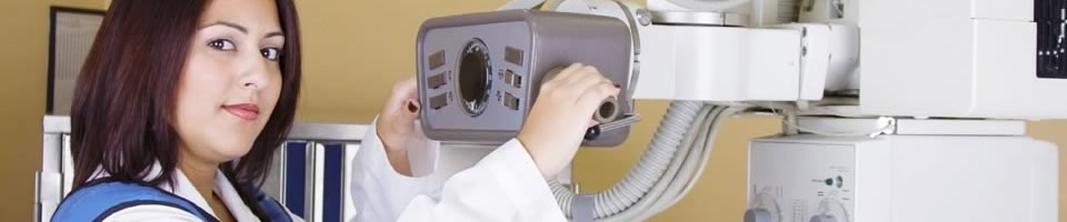 A female x-ray technician grasping the machine